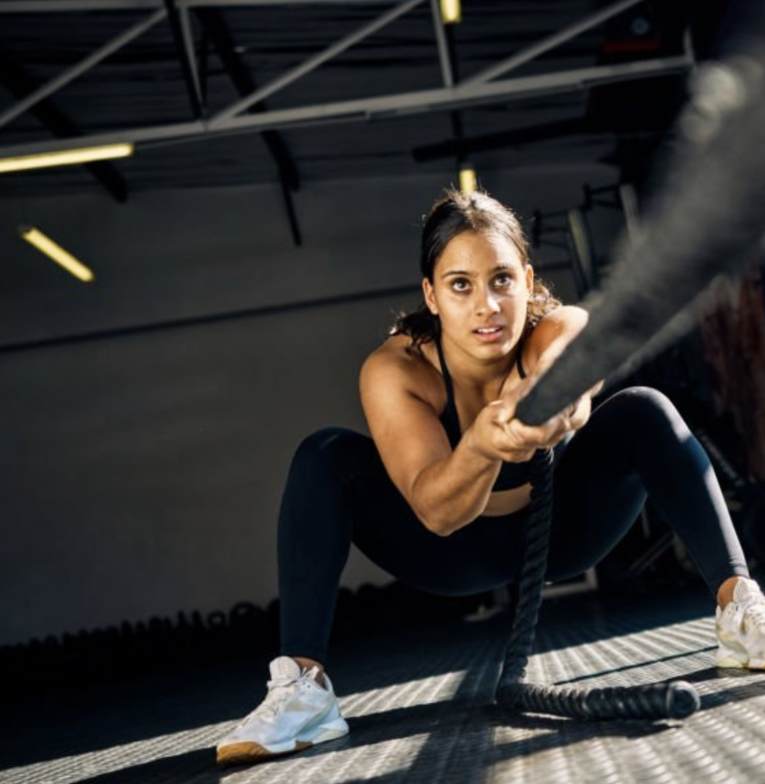Woman doing battle rope training